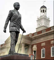 A monument of a man outside of a courthouse