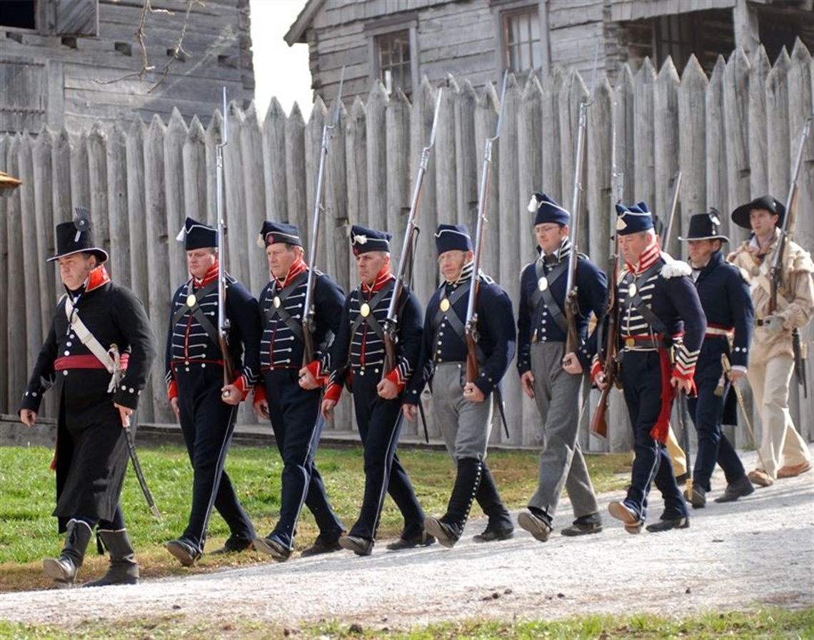 Soldiers march out into the field as they leave Fort Osage