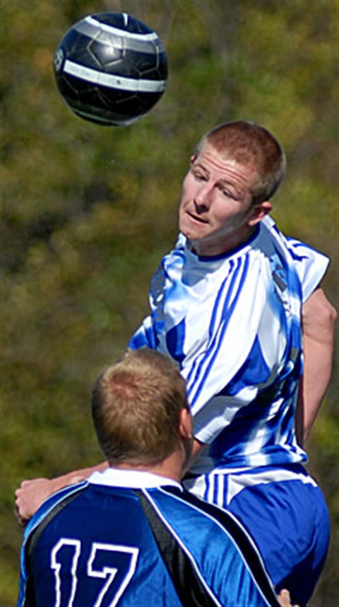 A soccer player about to head-hit a ball