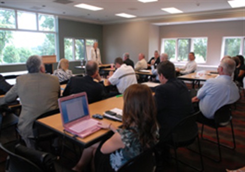 People sitting at desks in the golf course meeting room