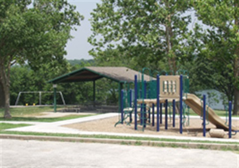 A playground near a pavilion in a park
