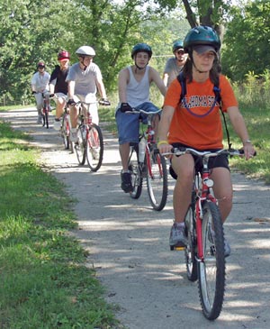 A group of people on bikes on the sidewalk